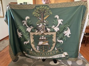 Close-up of the green Woodworth family crest flag, its Celtic border and motto.